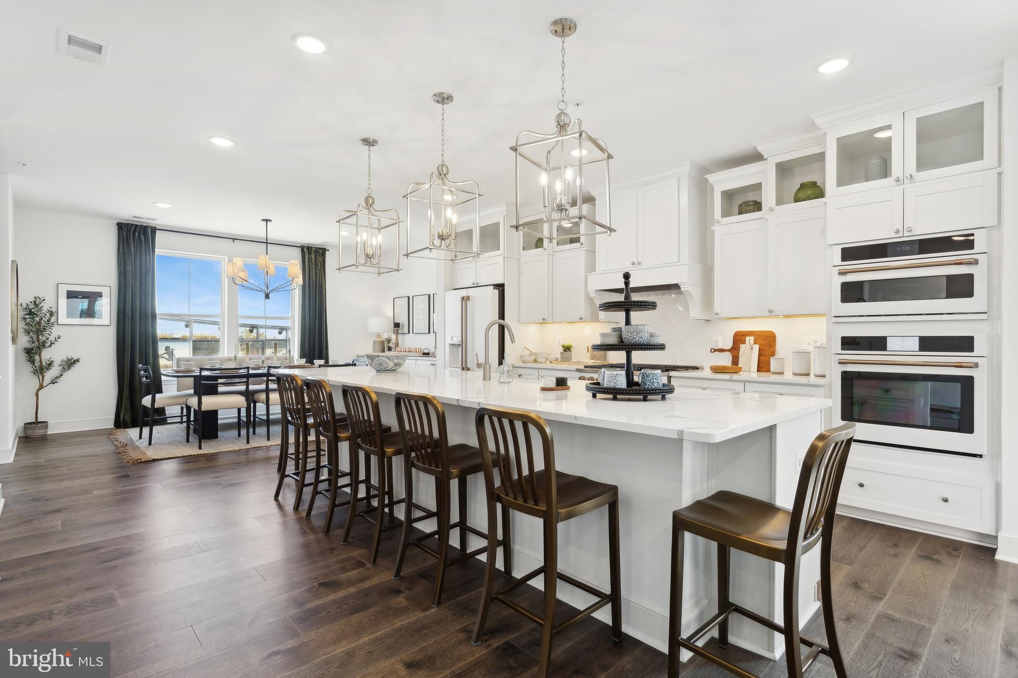 128 Locke Street, Unit 2029 Baltimore, MD 21230 - Photo 16 of 29 a kitchen with stainless steel appliances kitchen island granite countertop a table and chairs in it