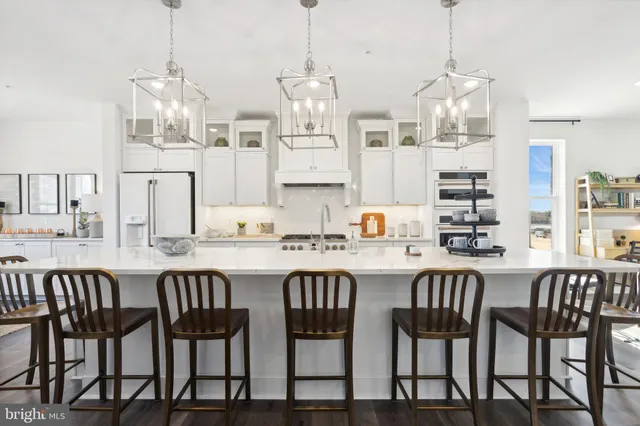 a large kitchen with a table and chairs