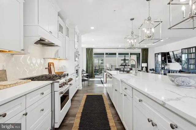 a large white kitchen with lots of counter space
