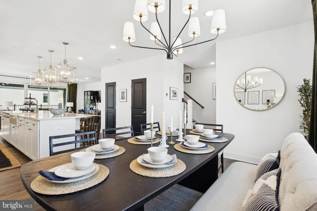 a dining room with furniture a mirror and kitchen view