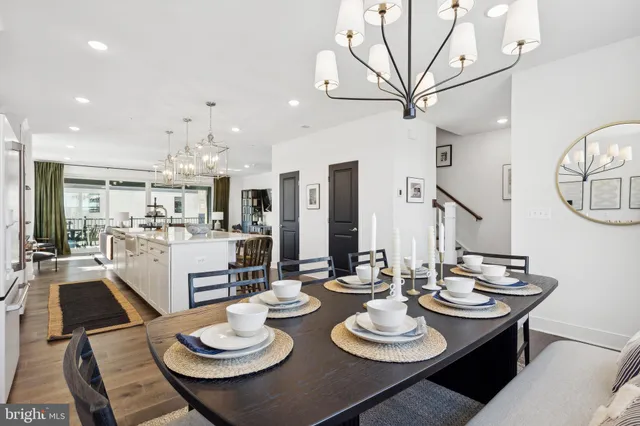 a kitchen with stainless steel appliances a dining table and chairs