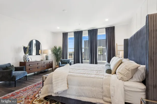 a bedroom with furniture and a large mirror