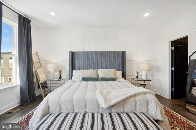 a bedroom with a bed and a large mirror