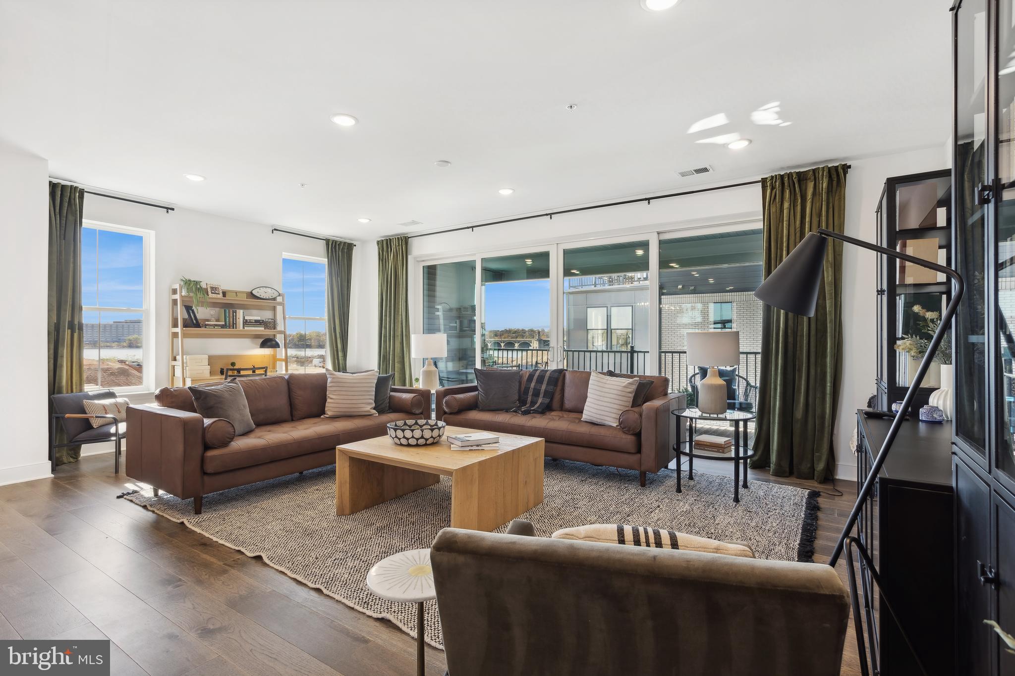 128 Locke Street, Unit 2029 Baltimore, MD 21230 - Photo 3 of 29 a living room with furniture flat screen tv and a large window