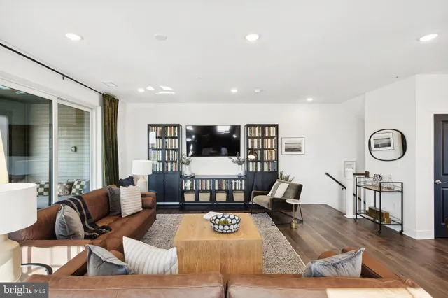 a living room with furniture and view of kitchen