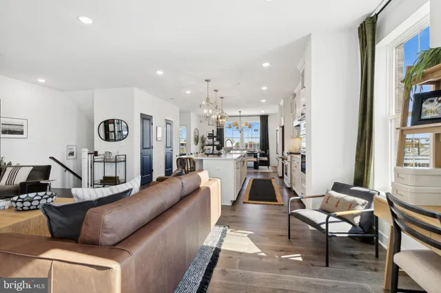 a living room with furniture kitchen and a table