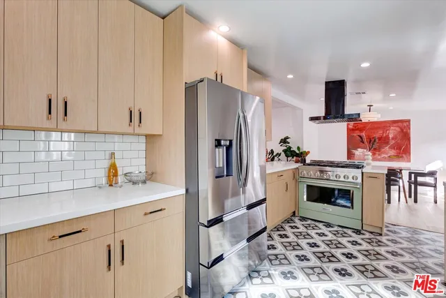 a kitchen with stainless steel appliances a refrigerator stove and sink