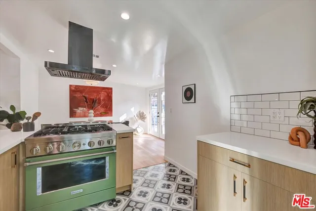 a stove top oven sitting inside of a kitchen