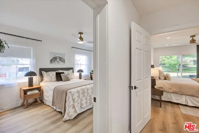 a bedroom with a bed and a large window