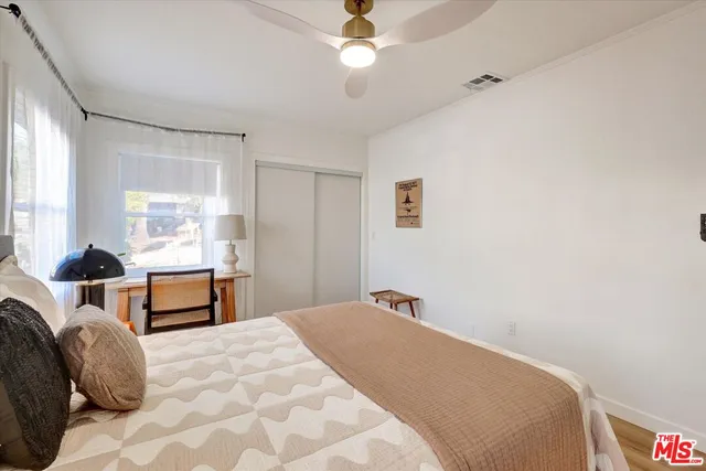 a bedroom with a bed and window