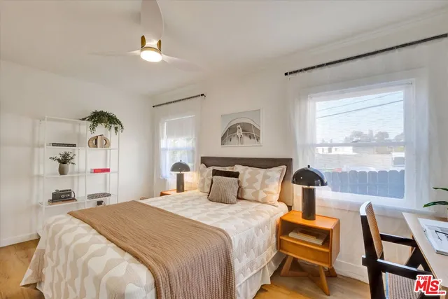 a bedroom with bed and window