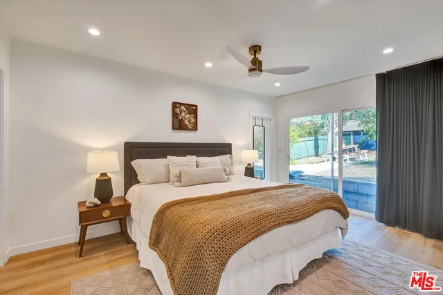 a bedroom with a large bed and a large window