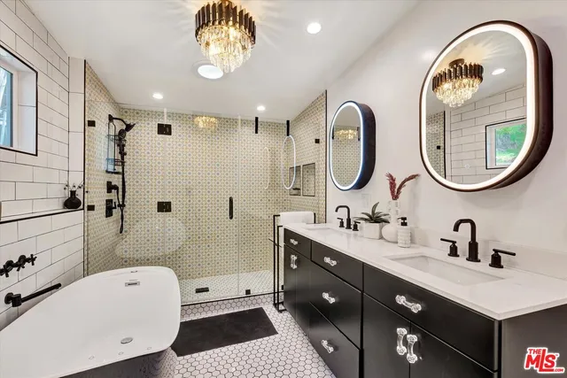 a spacious bathroom with a sink a mirror and a bathtub