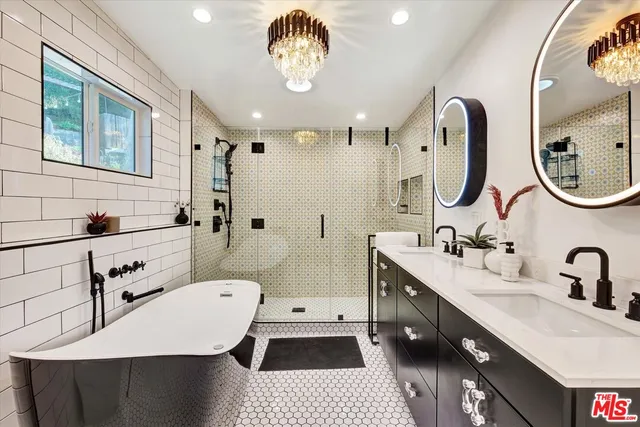 a en suite bathroom with a double vanity sink and a mirror