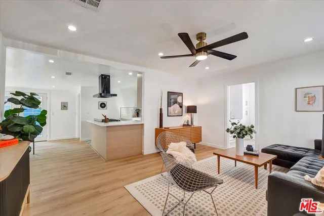 a living room with furniture and a potted plant