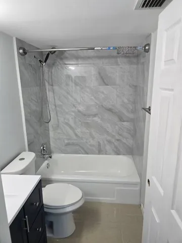 a bathroom with a toilet and a bathtub