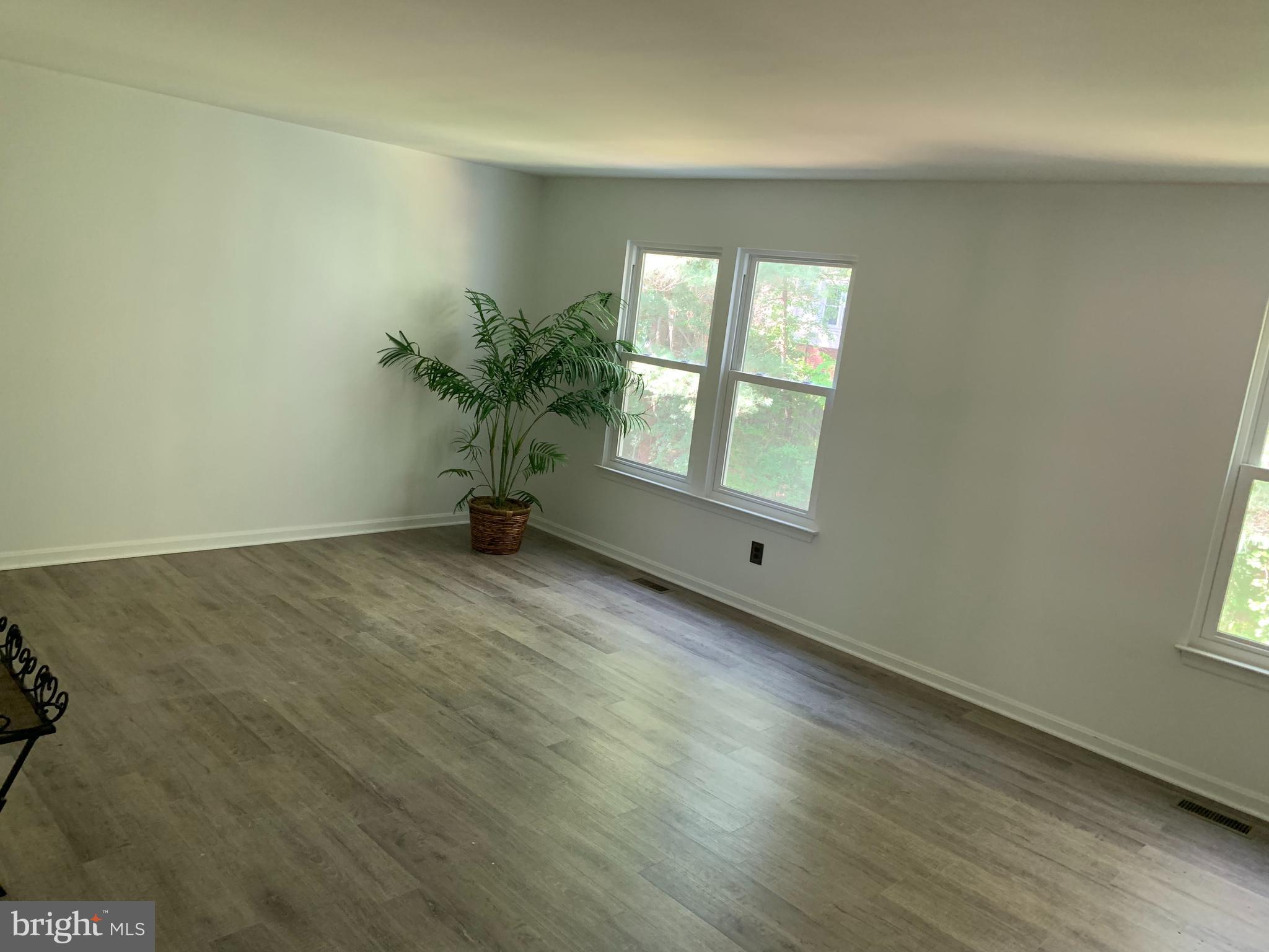 5478 Stavendish Street Burke, VA 22015 - Photo 11 of 24 an empty room with wooden floor and windows