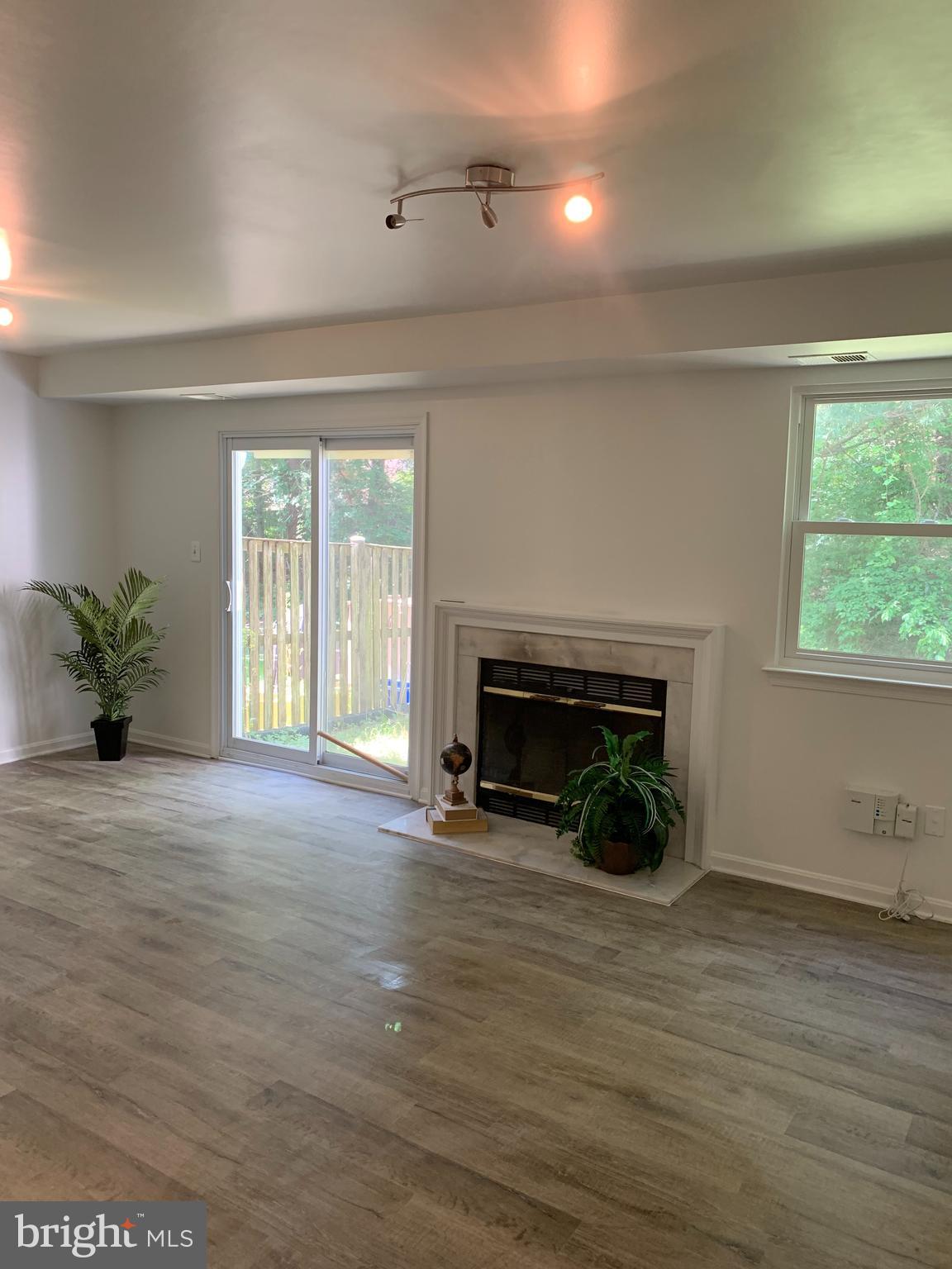 5478 Stavendish Street Burke, VA 22015 - Photo 14 of 24 a view of a livingroom with a fireplace and window