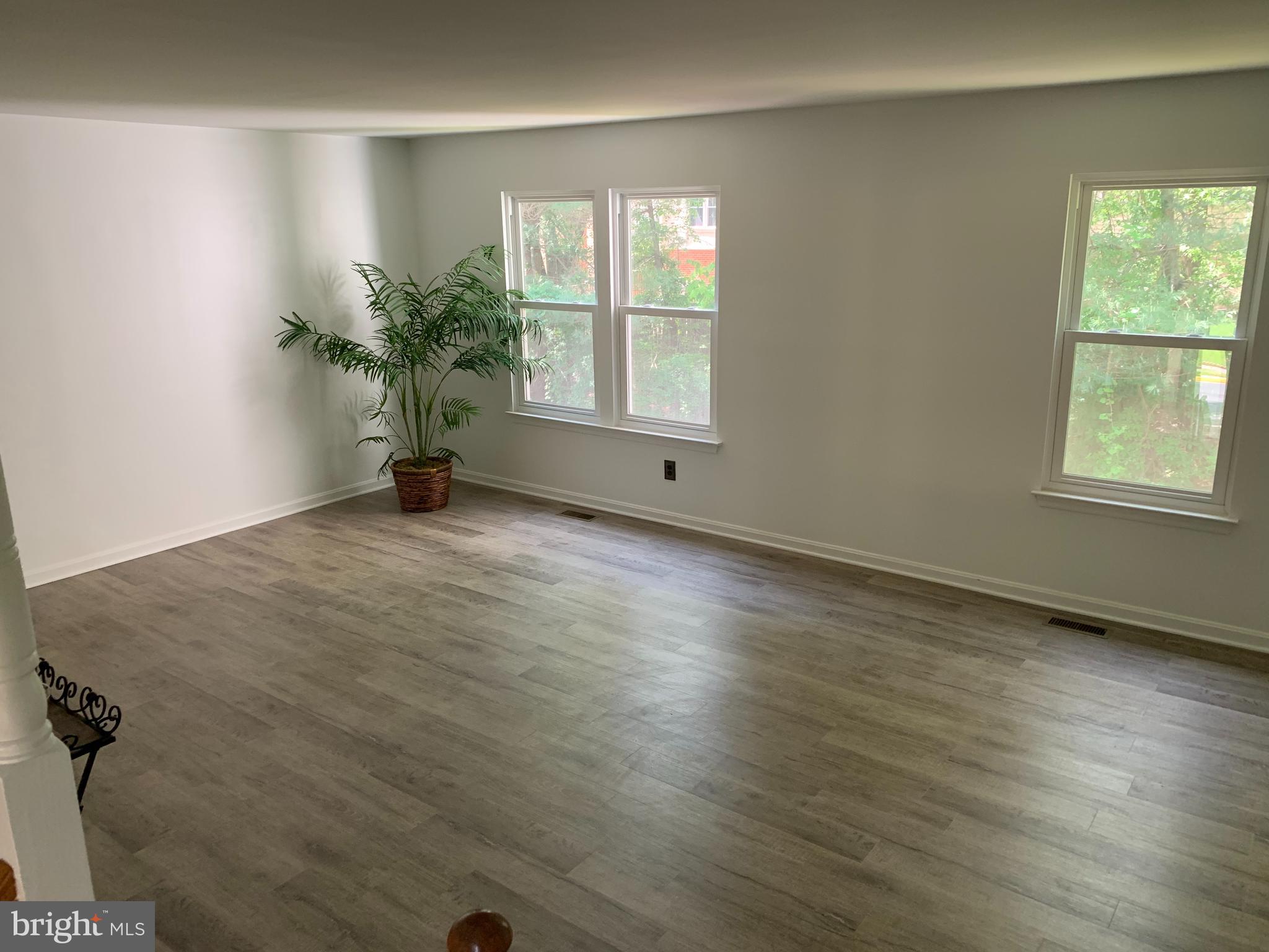 5478 Stavendish Street Burke, VA 22015 - Photo 15 of 24 an empty room with wooden floor and windows