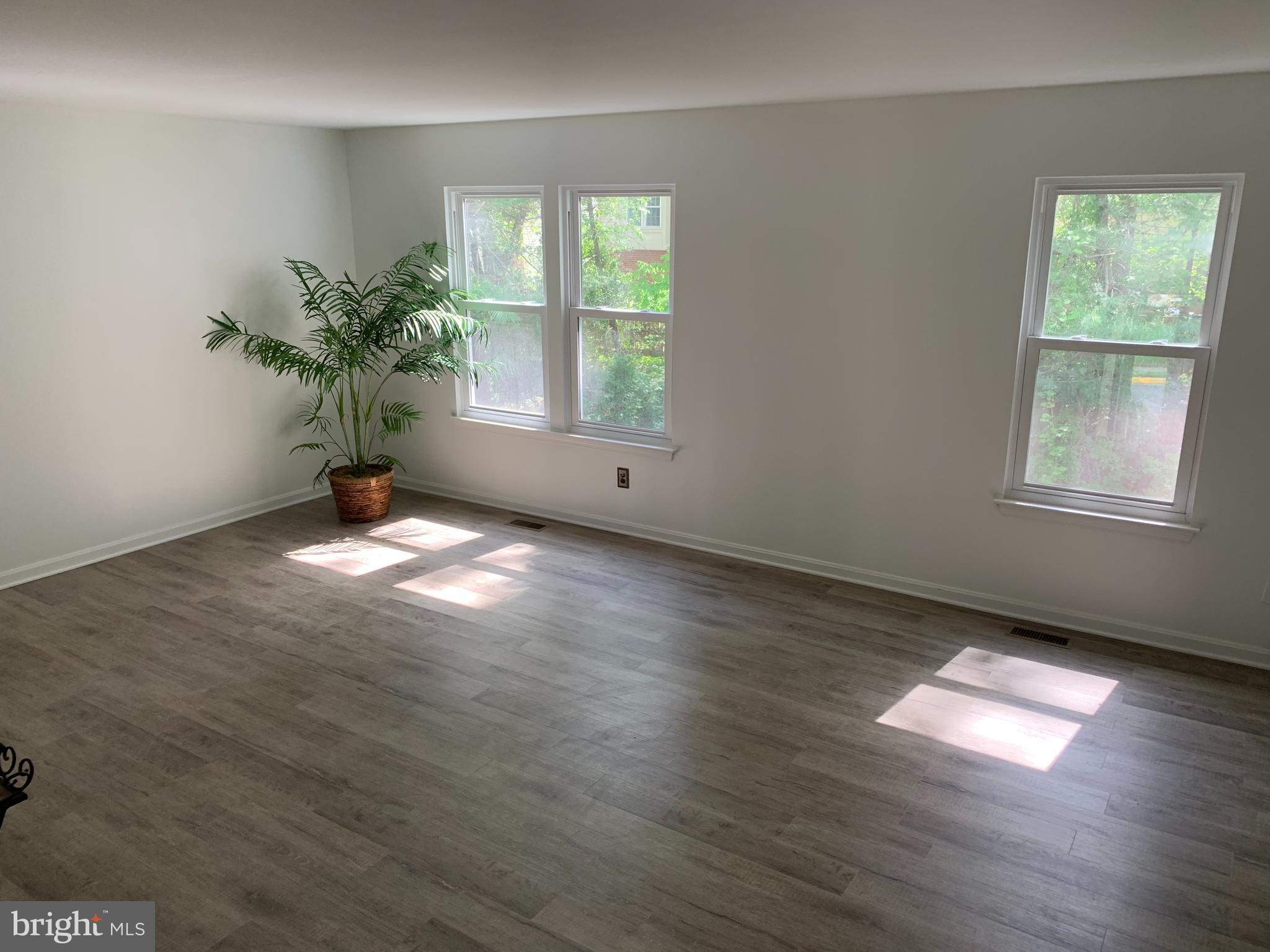 5478 Stavendish Street Burke, VA 22015 - Photo 20 of 24 a view of an empty room with wooden floor and a window