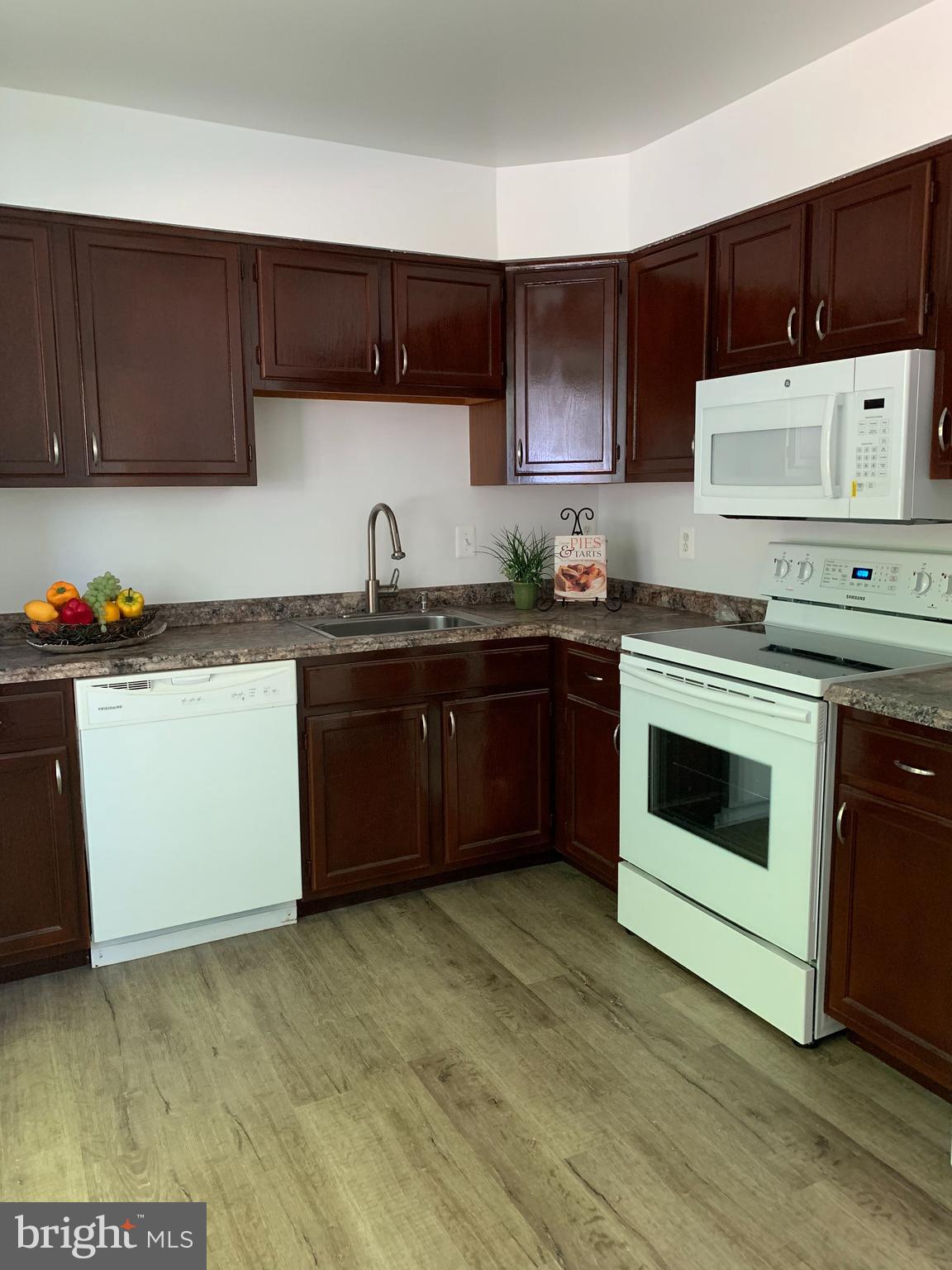 5478 Stavendish Street Burke, VA 22015 - Photo 3 of 24 a kitchen with a cabinets and white appliances