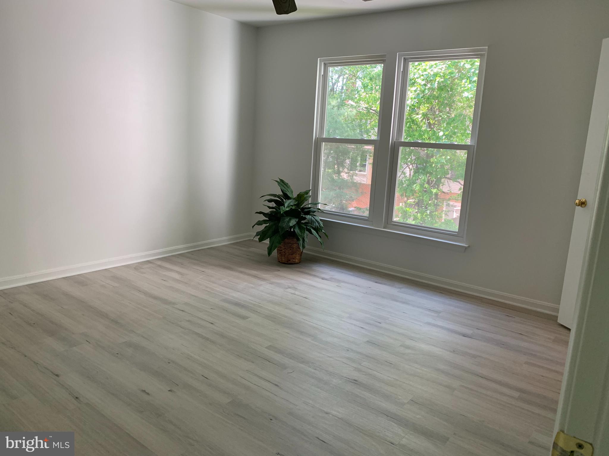 5478 Stavendish Street Burke, VA 22015 - Photo 5 of 24 an empty room with wooden floor and window