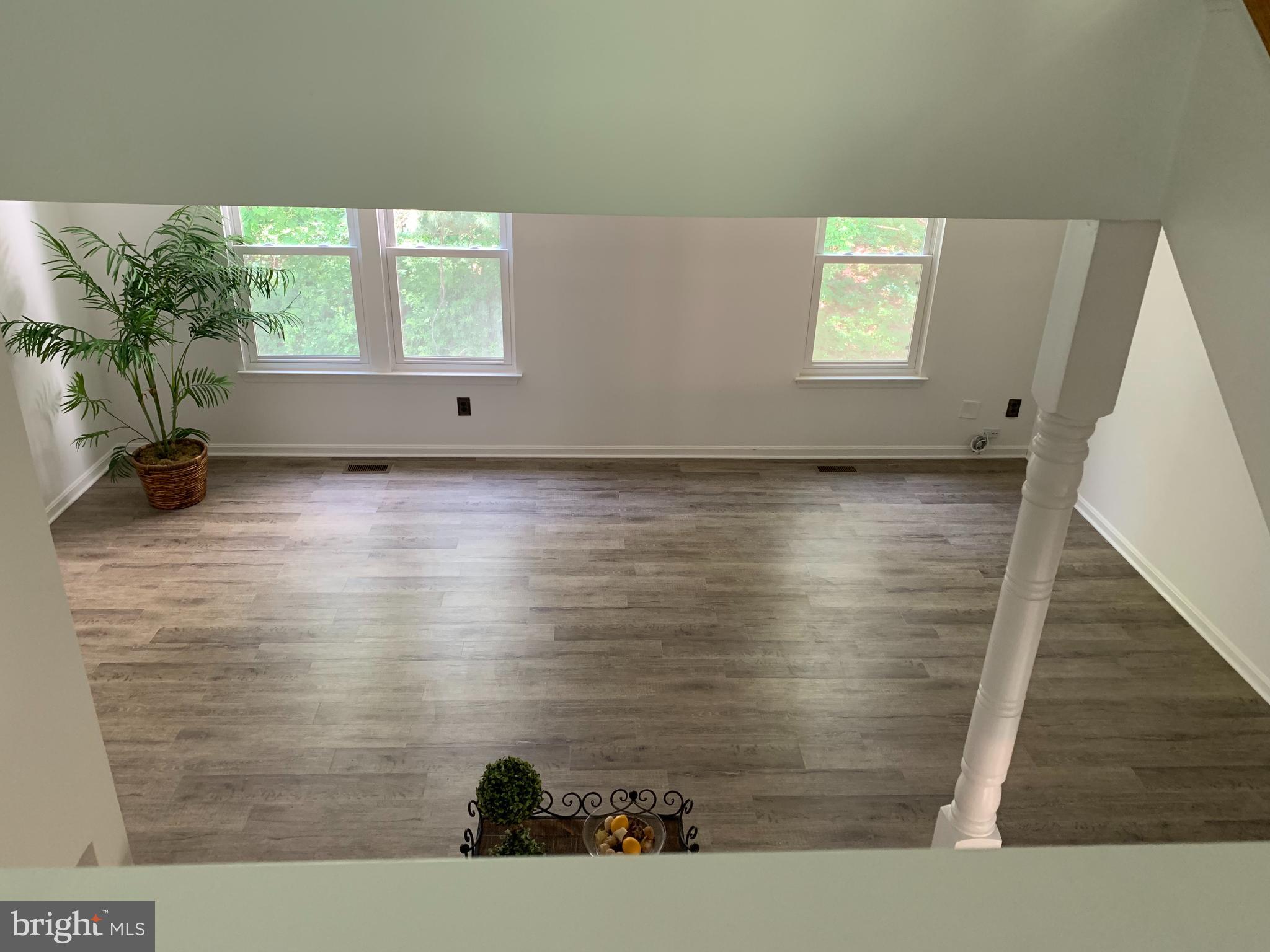 5478 Stavendish Street Burke, VA 22015 - Photo 6 of 24 a view of wooden floor and windows in a room