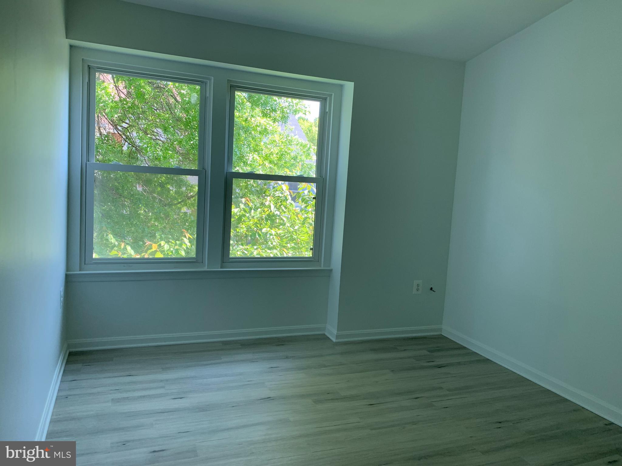 5478 Stavendish Street Burke, VA 22015 - Photo 7 of 24 an empty room with wooden floor and windows