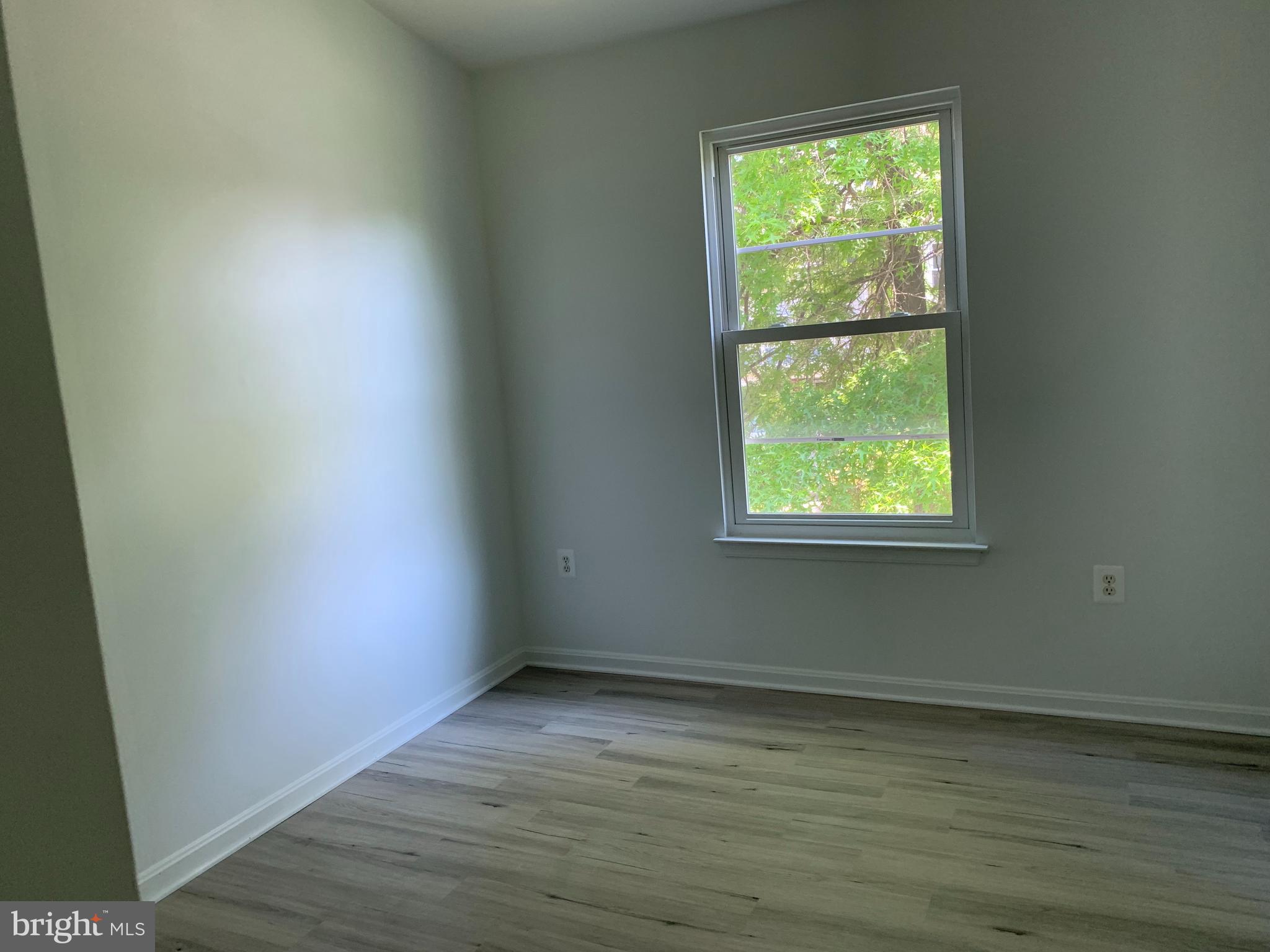 5478 Stavendish Street Burke, VA 22015 - Photo 8 of 24 an empty room with wooden floor and windows