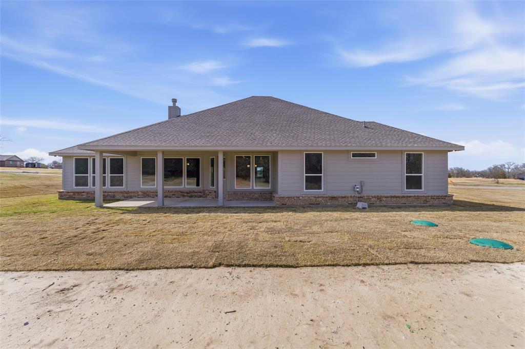 144 Oak Grv Way Springtown, TX 76082 - Photo 26 of 27 a front view of a house with a yard