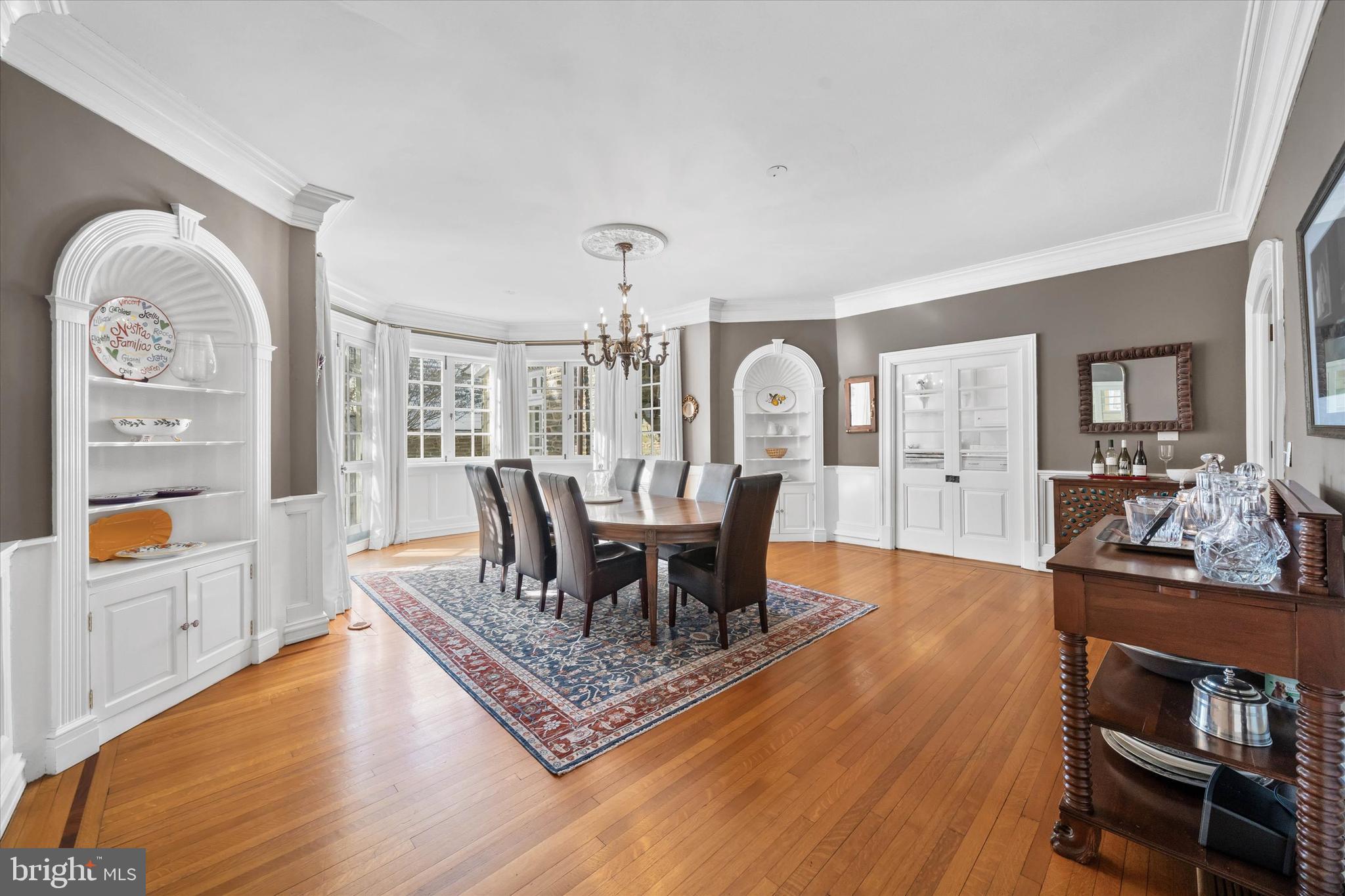 2412 Delaware Avenue Wilmington, DE 19806 - Photo 13 of 64 a dining room with wooden floor a chandelier a wooden table and chairs