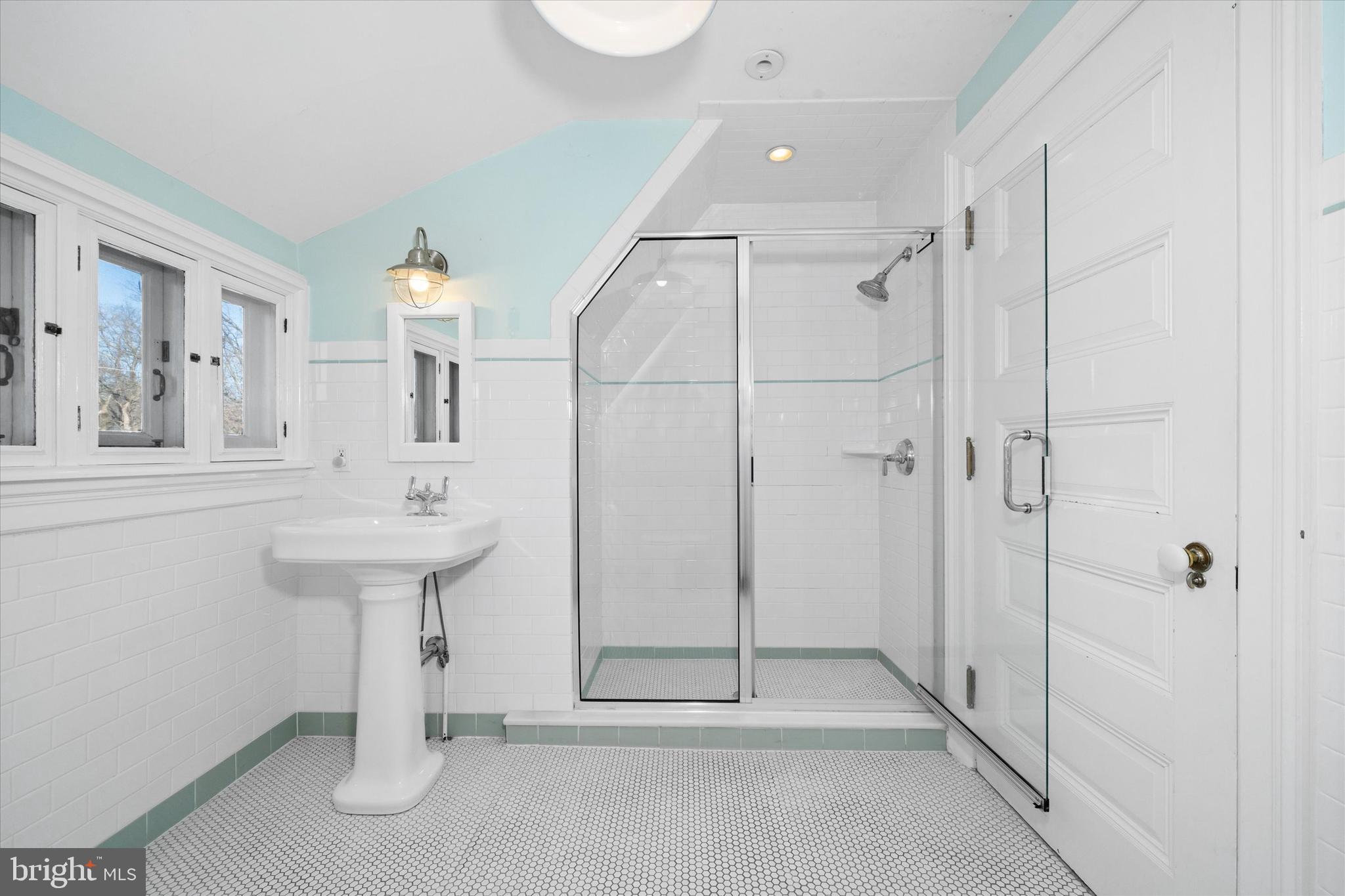 2412 Delaware Avenue Wilmington, DE 19806 - Photo 41 of 64 a spacious bathroom with a shower sink and mirror