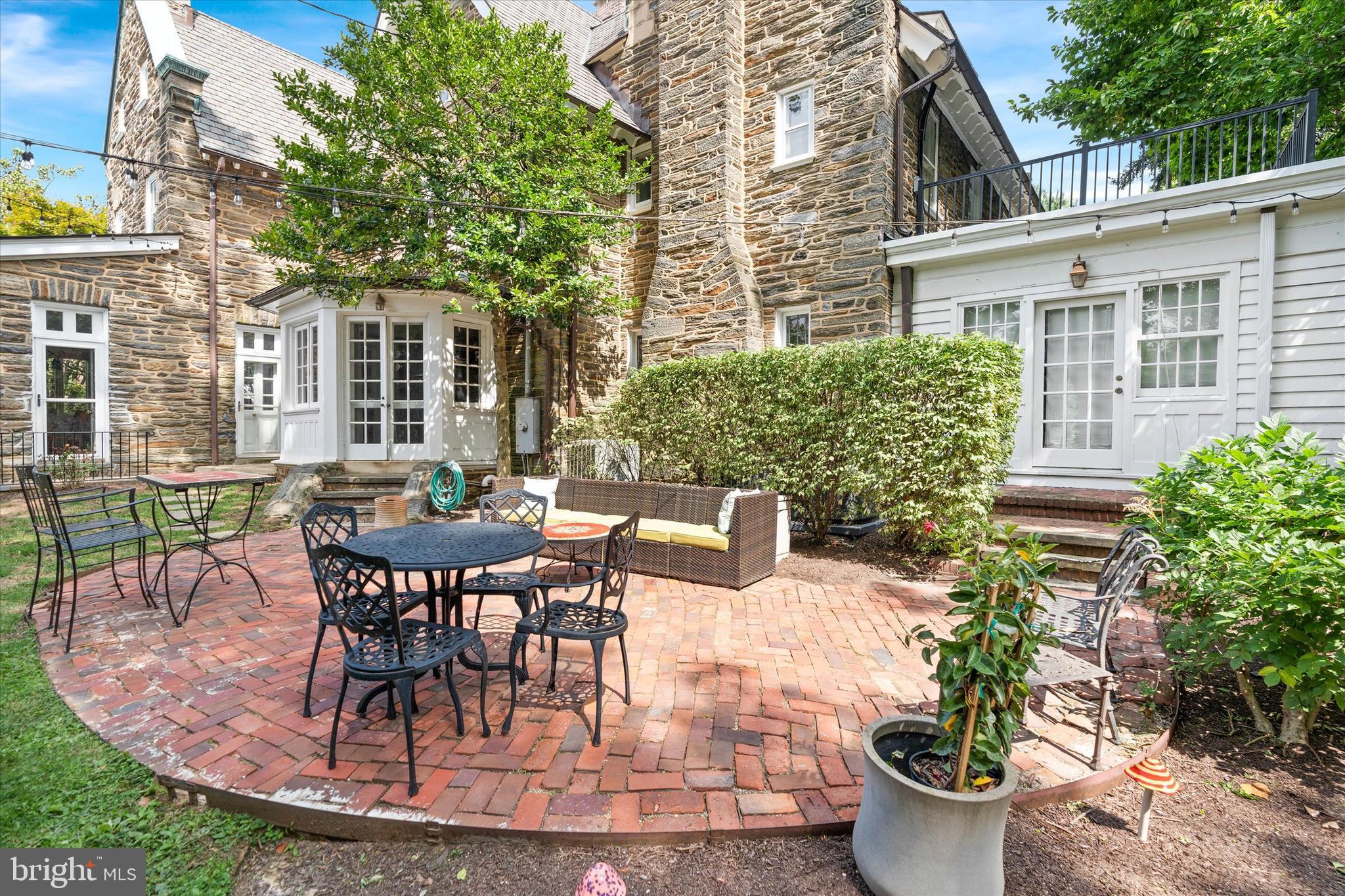 2412 Delaware Avenue Wilmington, DE 19806 - Photo 61 of 64 a view of a patio with table and chairs potted plants and floor to ceiling window and wooden floor