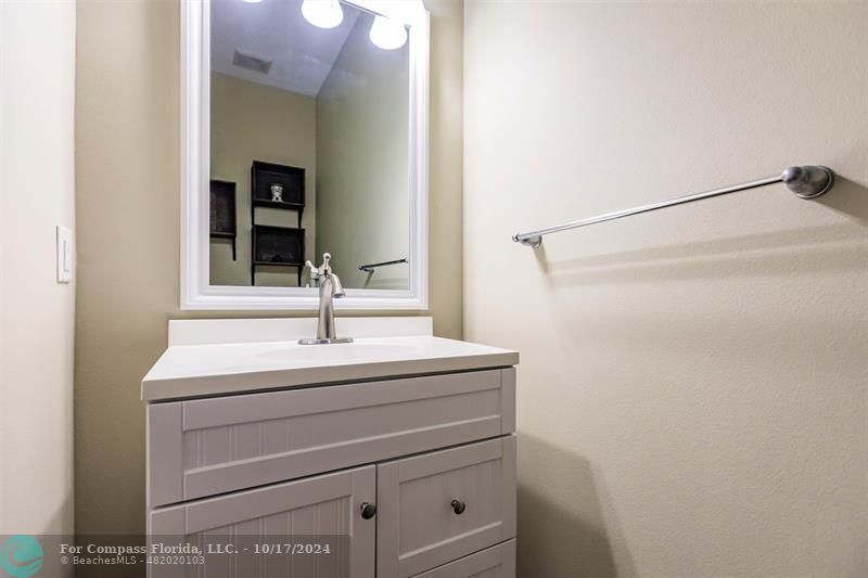 116 Southeast Crestwood Circle Stuart, FL 34997 - Photo 12 of 48 a sink and a mirror
