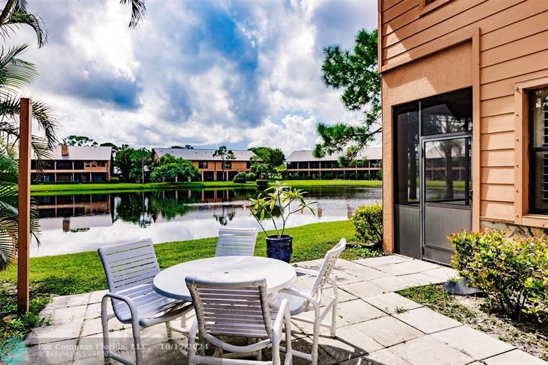 116 Southeast Crestwood Circle Stuart, FL 34997 - Photo 19 of 48 a view of a chair and tables in the patio