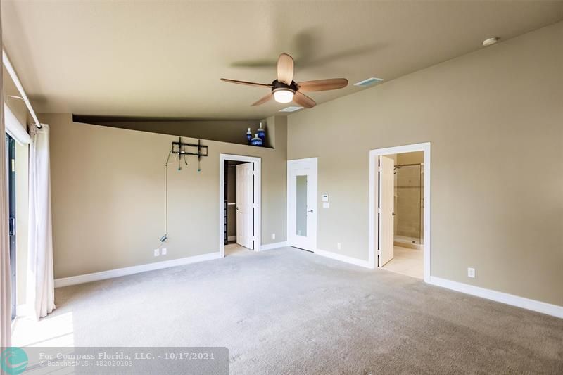 116 Southeast Crestwood Circle Stuart, FL 34997 - Photo 25 of 48 an empty room with ceiling fan and window