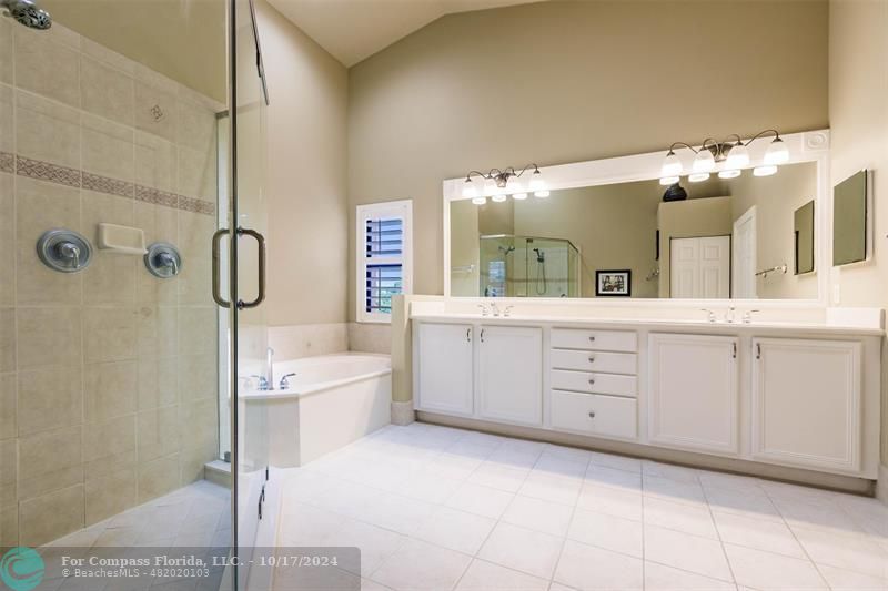 116 Southeast Crestwood Circle Stuart, FL 34997 - Photo 28 of 48 a spacious bathroom with a double vanity sink a mirror and a bathtub