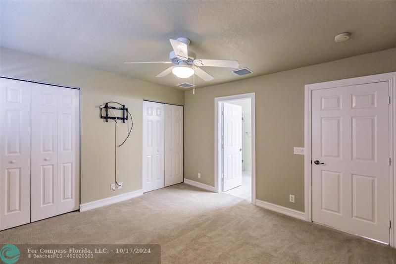 116 Southeast Crestwood Circle Stuart, FL 34997 - Photo 34 of 48 an empty room with closet and a ceiling fan