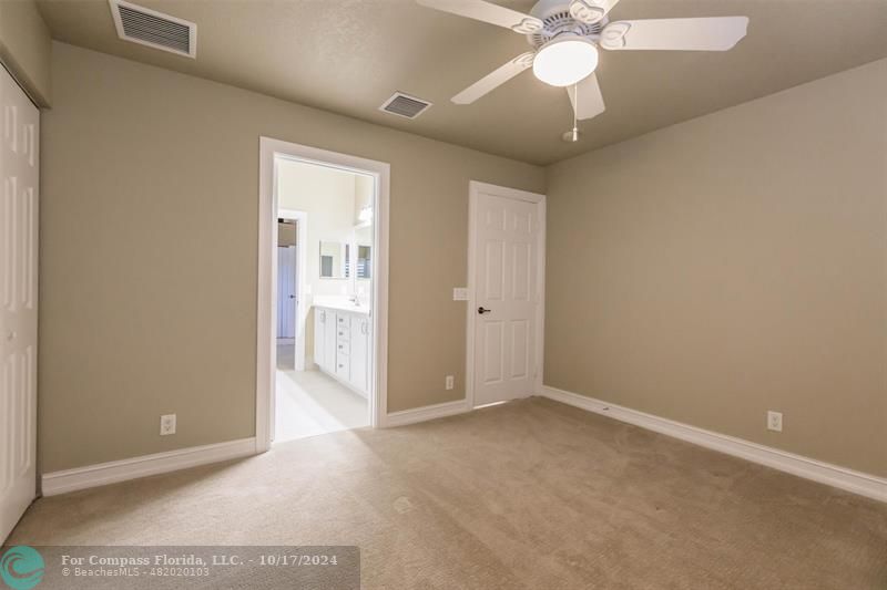 116 Southeast Crestwood Circle Stuart, FL 34997 - Photo 35 of 48 an empty room with closet and a chandelier fan