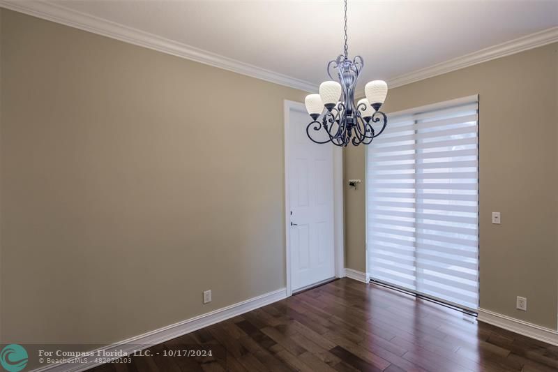 116 Southeast Crestwood Circle Stuart, FL 34997 - Photo 10 of 48 a view of a chandelier in big room with wooden floor