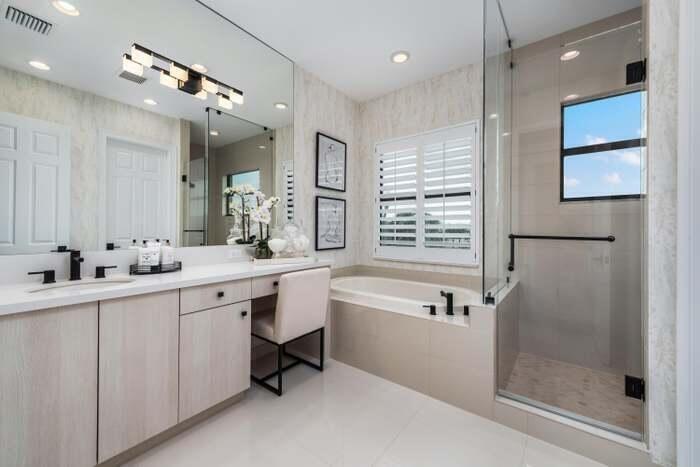 17166 Ludovica Lane Boca Raton, FL 33496 - Photo 8 of 24 a bathroom with a double vanity sink a mirror a bathtub and shower