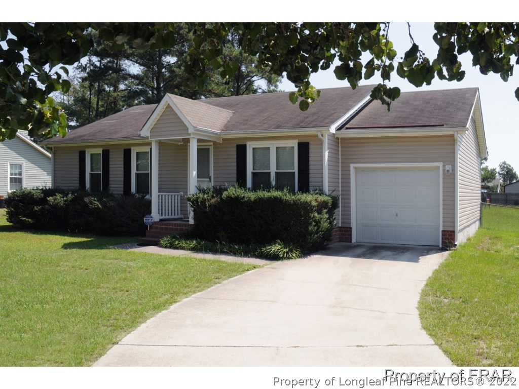 10071 Rockfish Road Raeford, NC 28376 - Photo 1 of 15 a front view of a house with yard and green space