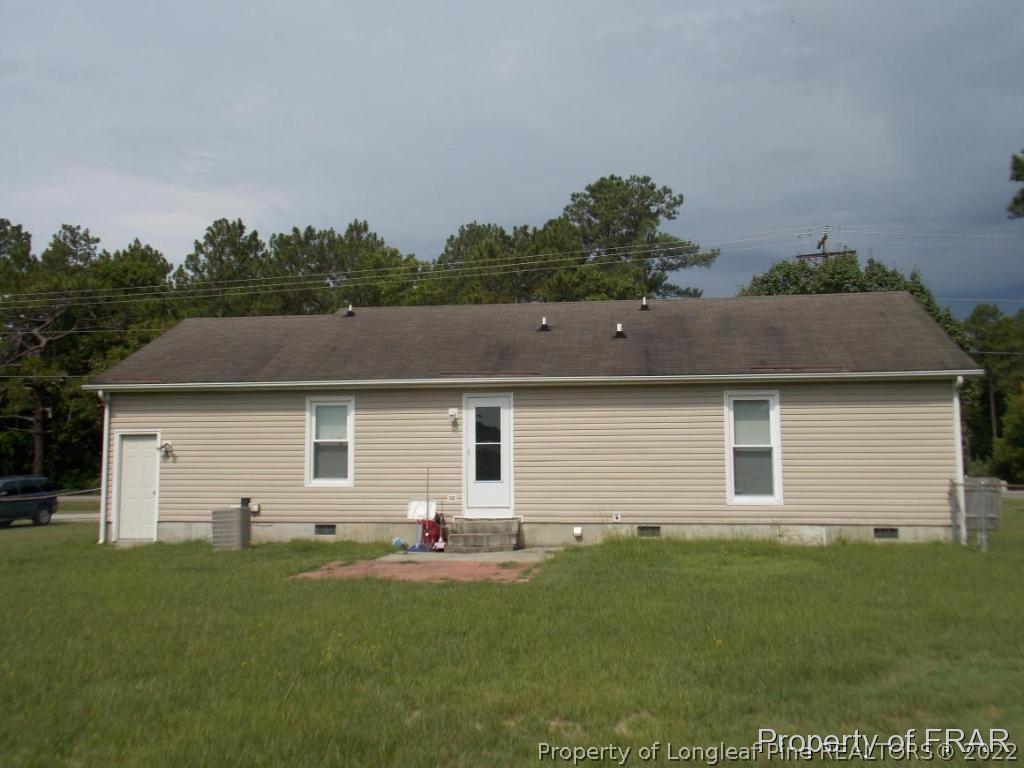 10071 Rockfish Road Raeford, NC 28376 - Photo 15 of 15 a front view of house with yard and trees in the background