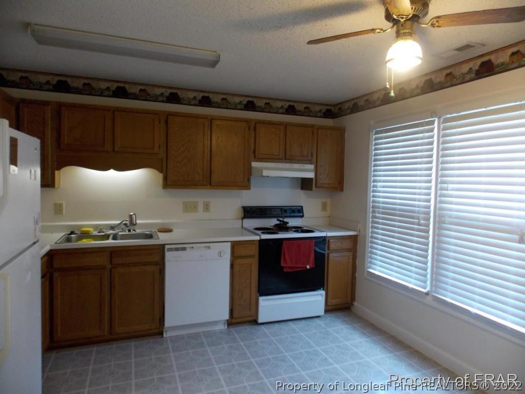 10071 Rockfish Road Raeford, NC 28376 - Photo 5 of 15 a kitchen with stainless steel appliances granite countertop a sink and a stove