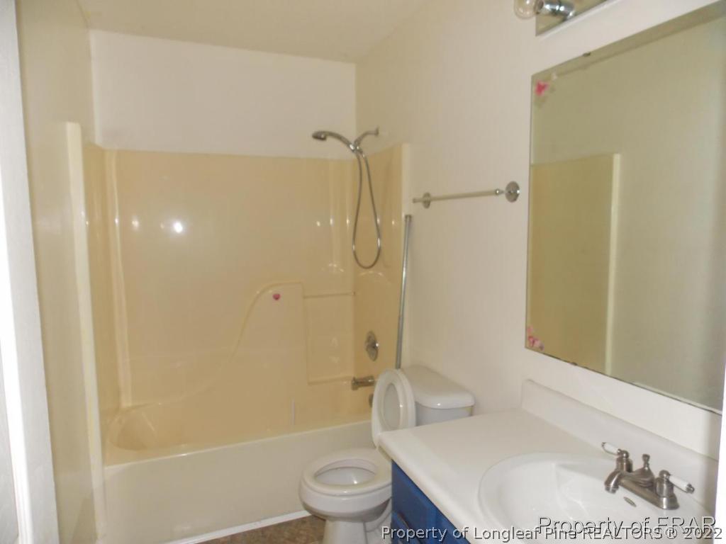 10071 Rockfish Road Raeford, NC 28376 - Photo 7 of 15 a bathroom with a sink toilet and shower