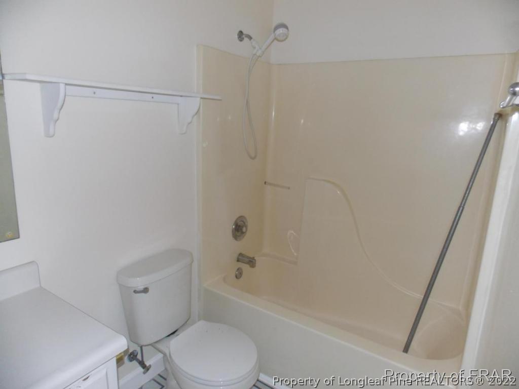 10071 Rockfish Road Raeford, NC 28376 - Photo 9 of 15 a white toilet sitting next to a bath tub