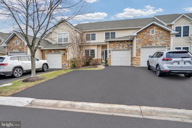 a view of an empty room with window and chandelier