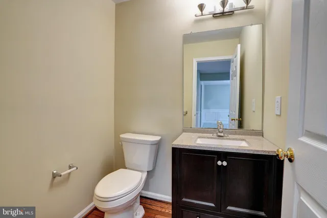 an empty room with windows and fireplace