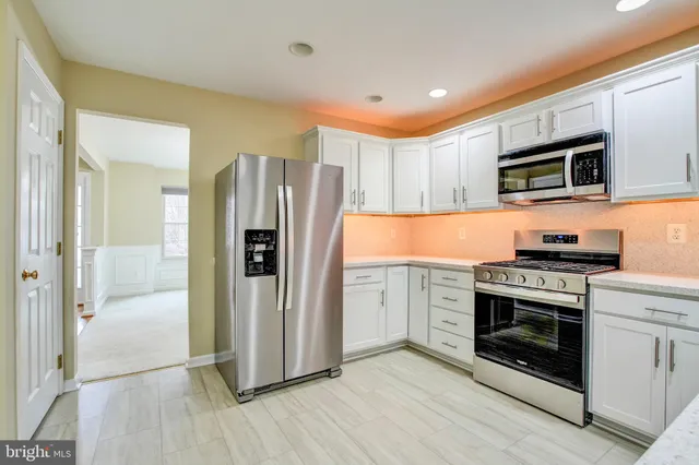a view of a kitchen with a sink and cabinets
