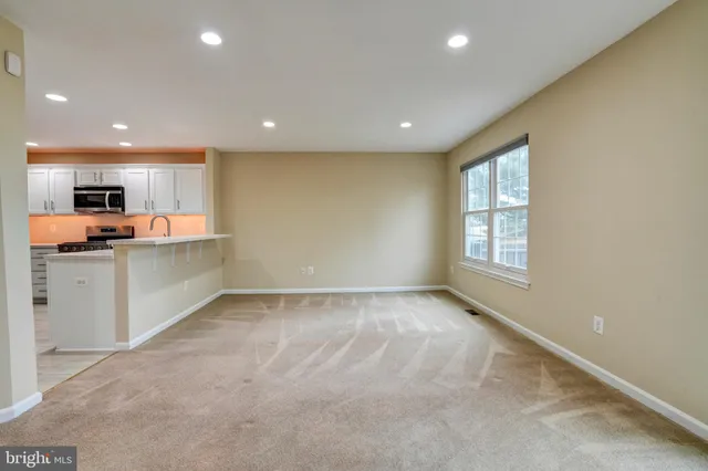 a view of a kitchen with a staircase and kitchen view